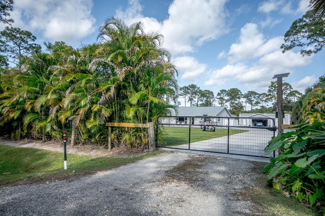 view of gate featuring a yard