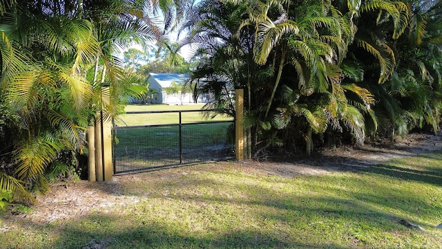 view of gate featuring a lawn