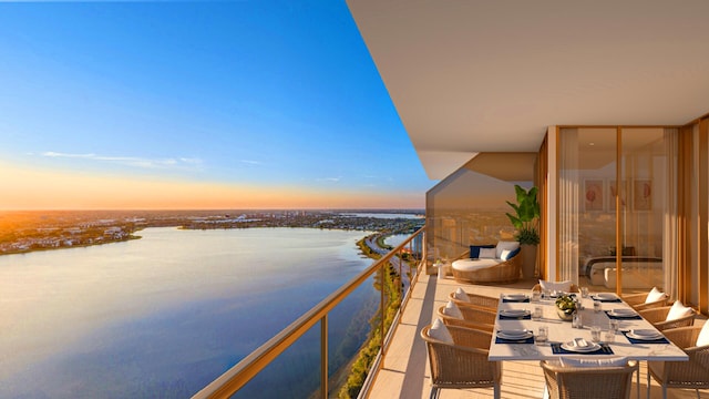 balcony at dusk featuring a water view