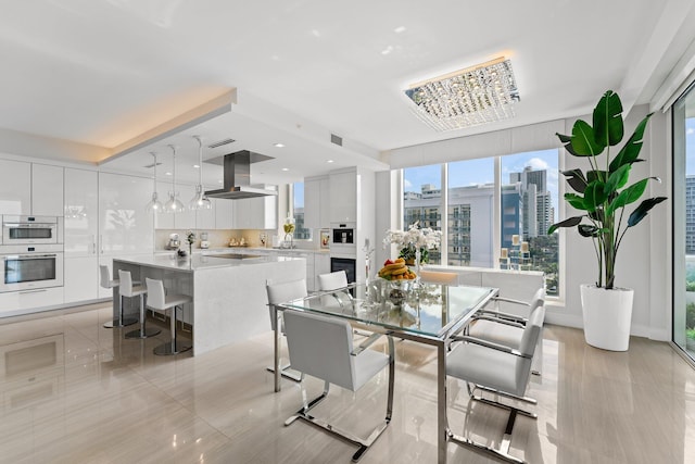 tiled dining space featuring a notable chandelier