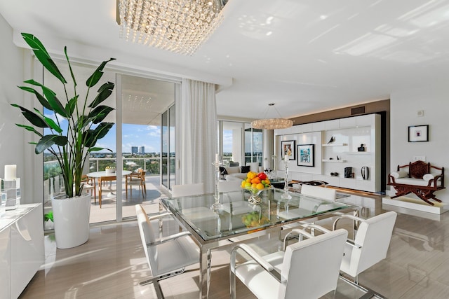 dining area featuring a chandelier and expansive windows