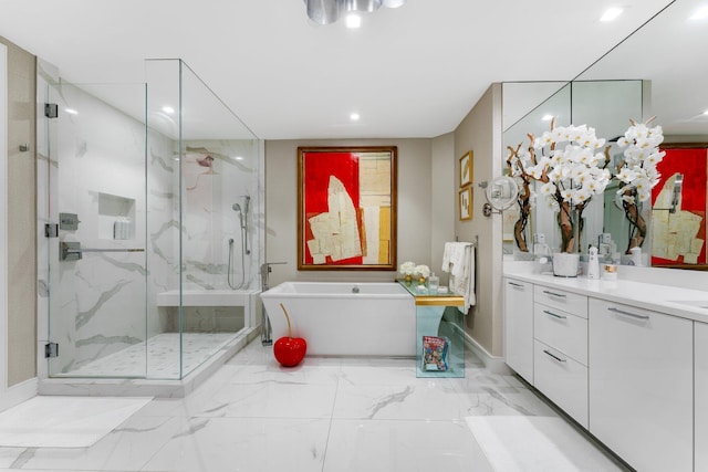 bathroom with vanity and independent shower and bath