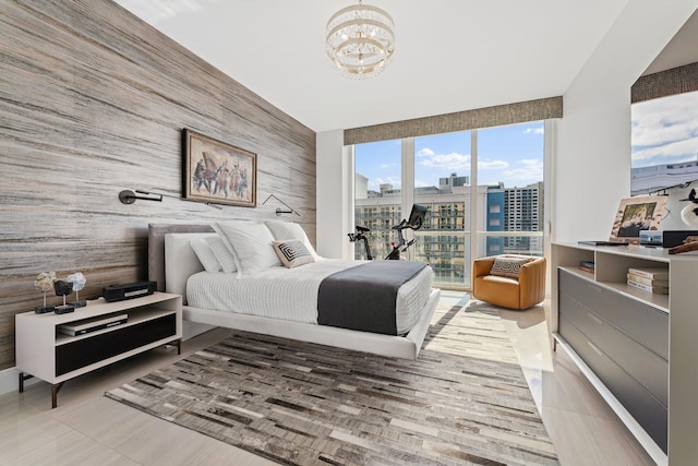 bedroom with wood walls and a notable chandelier