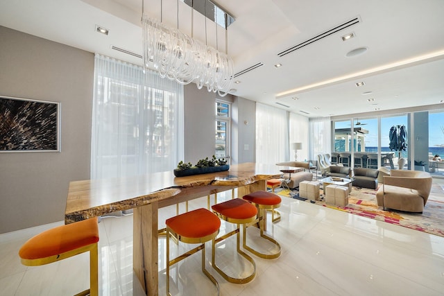 interior space with a chandelier, tile patterned floors, and plenty of natural light