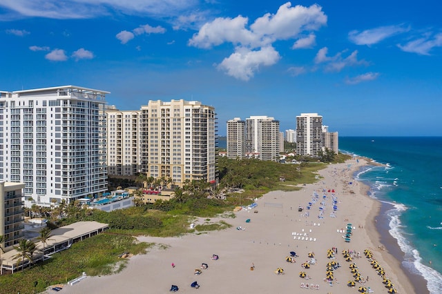 drone / aerial view featuring a water view and a view of the beach