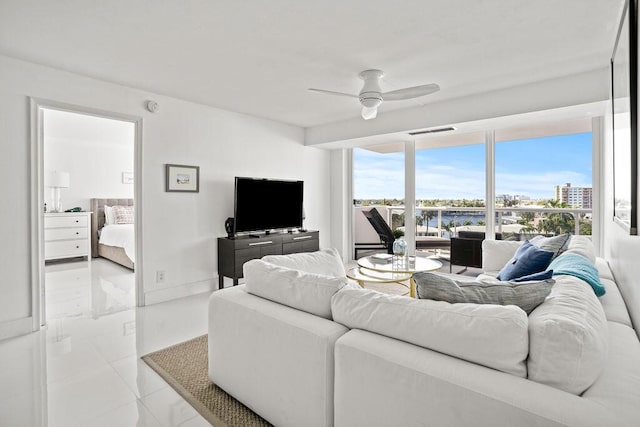 tiled living room with ceiling fan