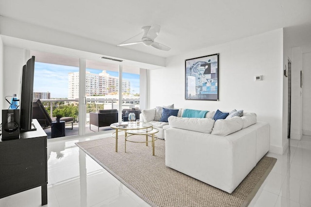 living room featuring ceiling fan and light tile patterned flooring