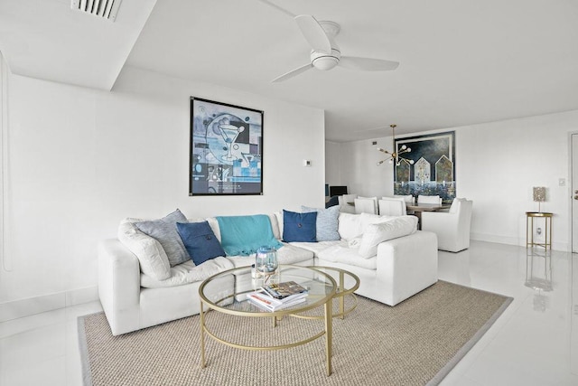 living room with ceiling fan with notable chandelier