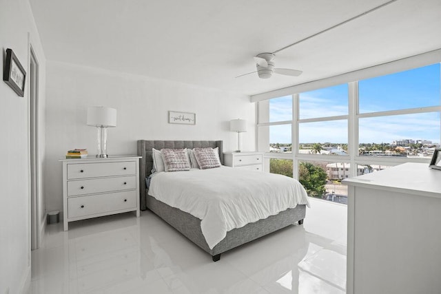 bedroom with ceiling fan and floor to ceiling windows