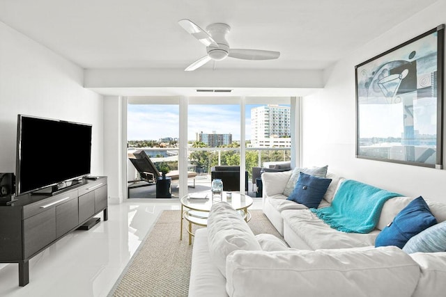 living room featuring light tile patterned floors, a wealth of natural light, and ceiling fan