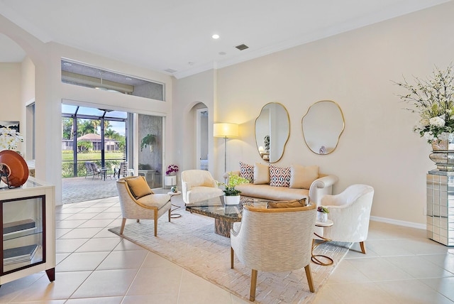 living room with light tile patterned floors and ornamental molding