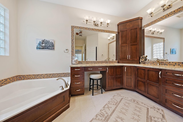 bathroom featuring a washtub, vanity, ceiling fan, and tile patterned flooring