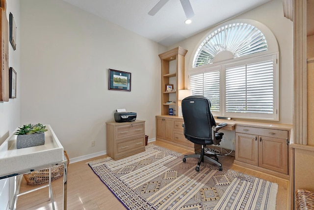 office space with light wood-type flooring and ceiling fan