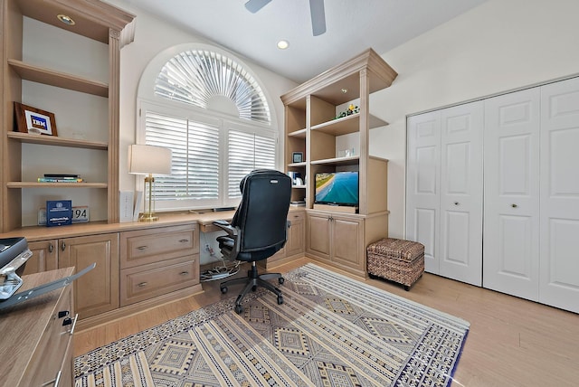 home office featuring light hardwood / wood-style flooring and ceiling fan