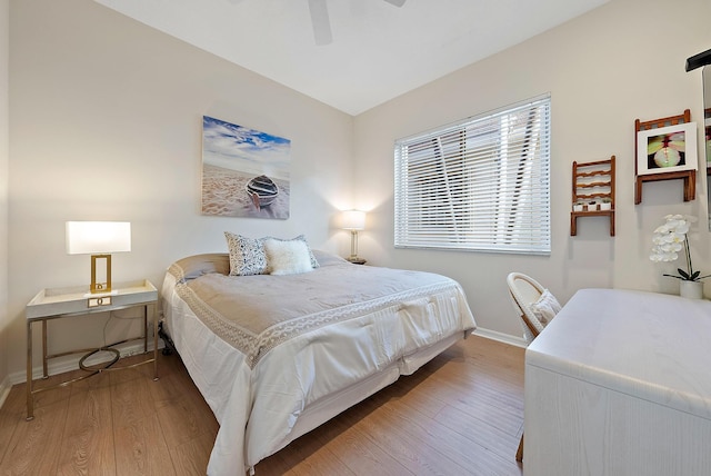 bedroom with ceiling fan and hardwood / wood-style floors