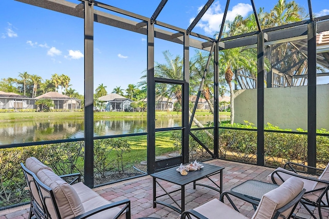 unfurnished sunroom featuring a water view