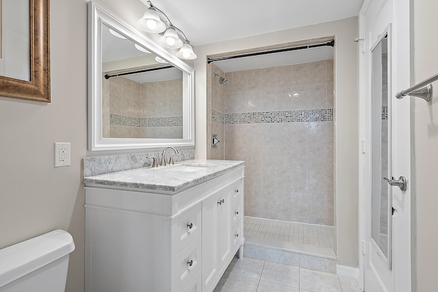 bathroom with toilet, a stall shower, tile patterned floors, and vanity