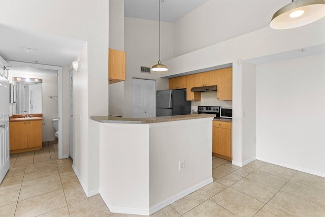 kitchen with black fridge, stainless steel electric range oven, light tile patterned floors, kitchen peninsula, and a towering ceiling