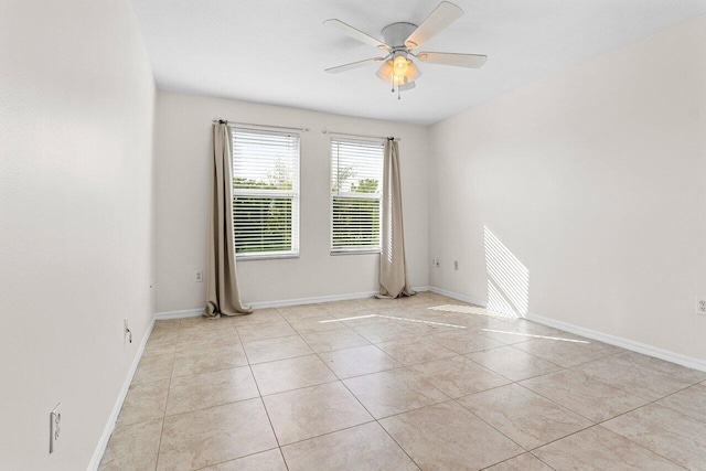 spare room with light tile patterned floors and ceiling fan