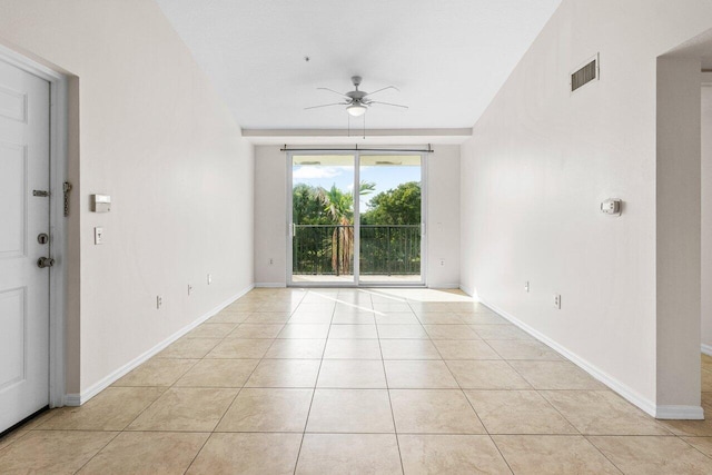 tiled empty room with ceiling fan