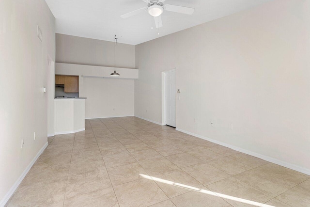 unfurnished living room featuring vaulted ceiling, ceiling fan, and light tile patterned flooring