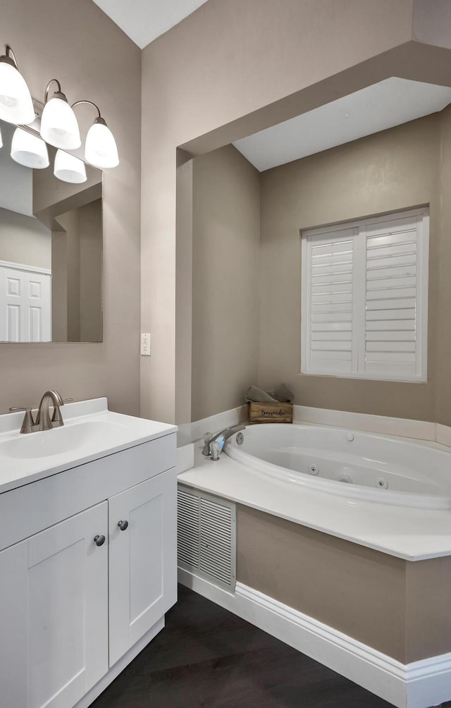 bathroom with a bathing tub, vanity, and hardwood / wood-style floors