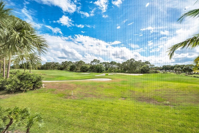 view of property's community featuring a lawn