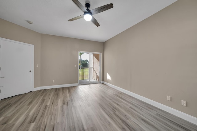 spare room with ceiling fan and light wood-type flooring