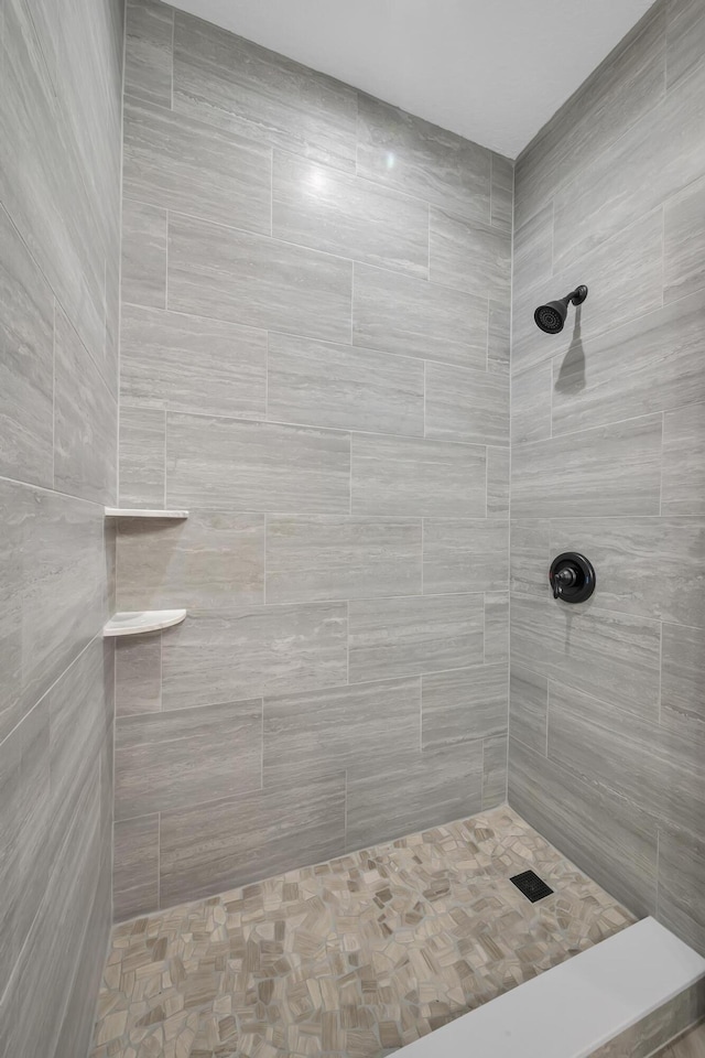 bathroom with a tile shower