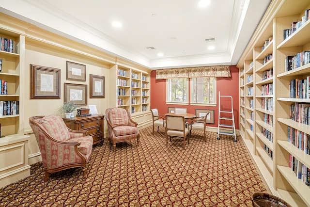 living area featuring carpet, a raised ceiling, and ornamental molding