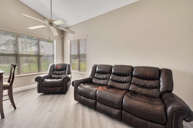 living room with ceiling fan, light wood-type flooring, and lofted ceiling