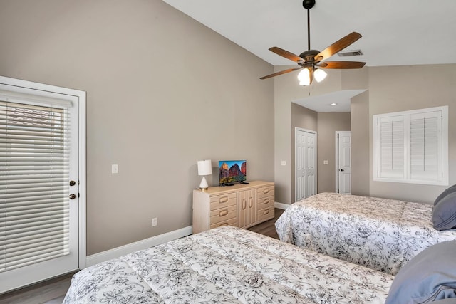 bedroom with ceiling fan, a closet, dark hardwood / wood-style flooring, and vaulted ceiling