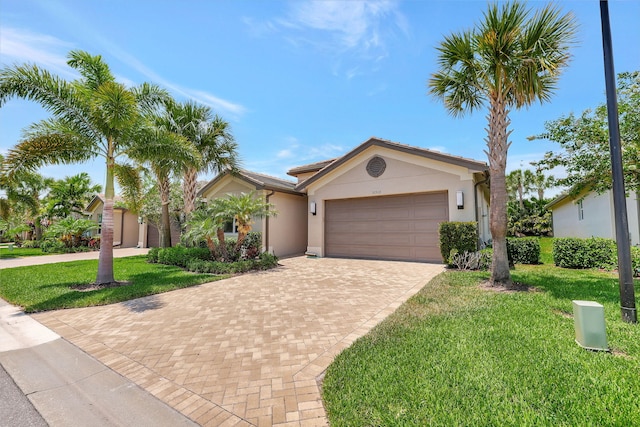 view of front of house featuring a garage and a front yard