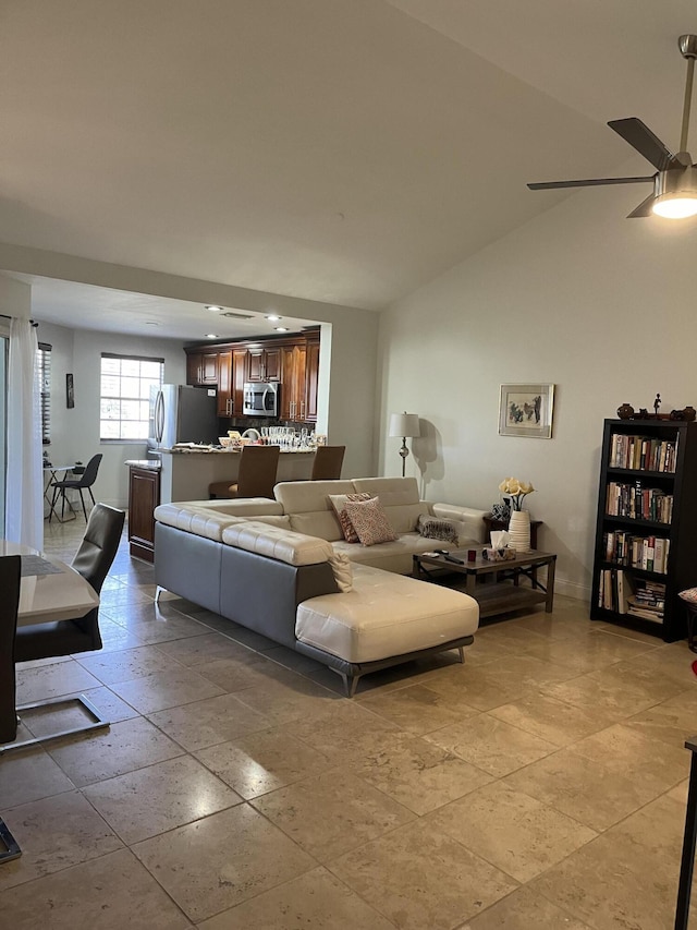 living room with ceiling fan and vaulted ceiling