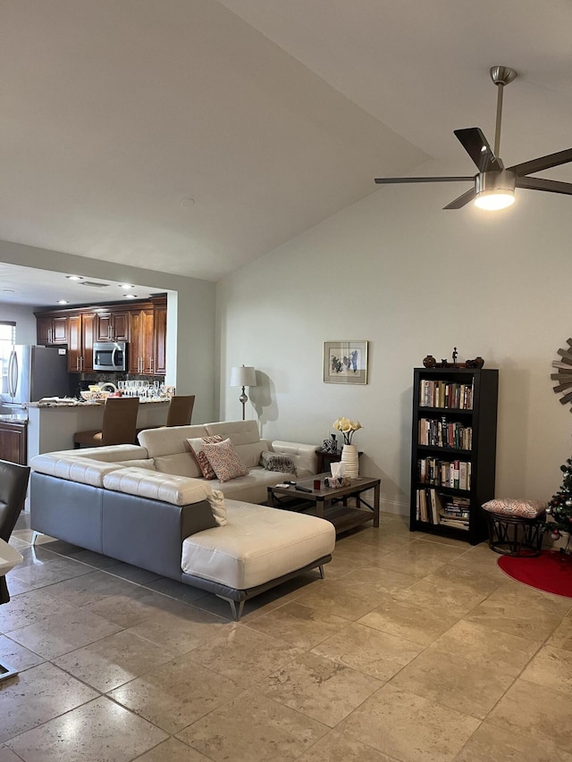 living room featuring ceiling fan and vaulted ceiling