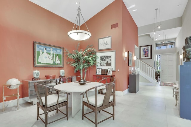 dining space with high vaulted ceiling