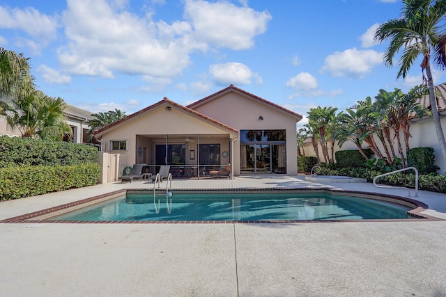 view of swimming pool featuring a patio and ceiling fan