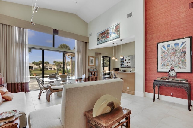 tiled living room with high vaulted ceiling