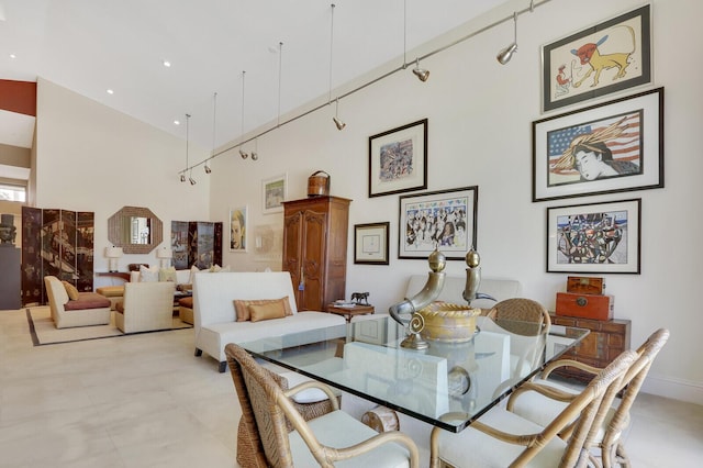 dining room with a towering ceiling