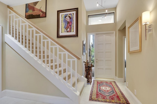 entryway featuring a towering ceiling