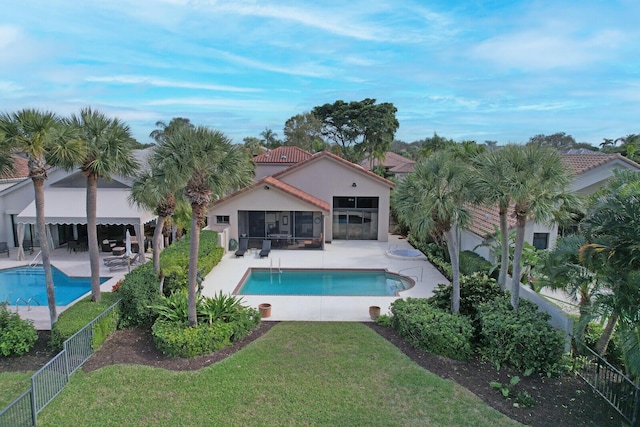 view of pool featuring a lawn and a patio area