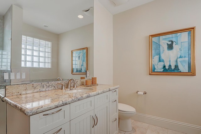 bathroom featuring tile patterned flooring, vanity, and toilet