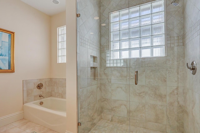 bathroom featuring separate shower and tub, tile patterned floors, and a healthy amount of sunlight