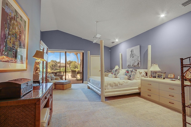 carpeted bedroom featuring access to exterior, a textured ceiling, and vaulted ceiling