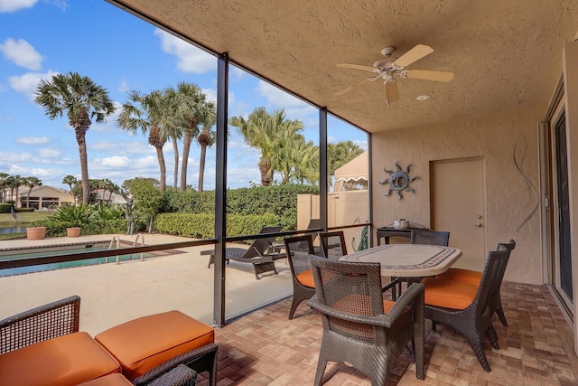 sunroom featuring ceiling fan