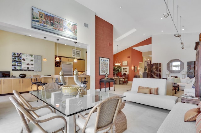 dining room featuring high vaulted ceiling