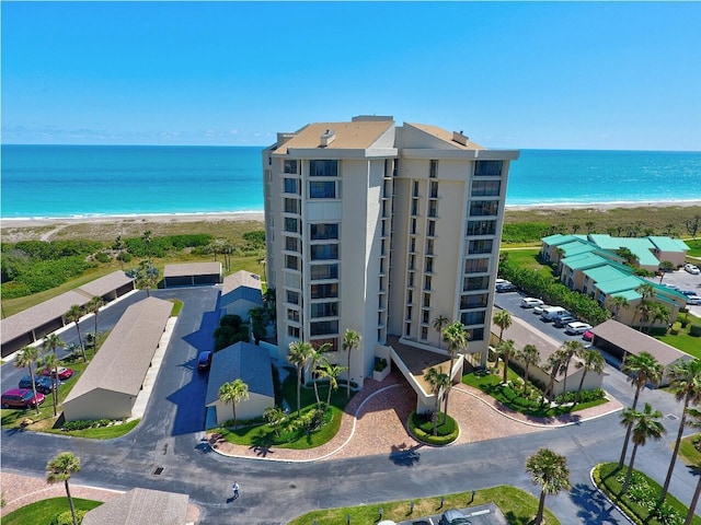 bird's eye view featuring a water view and a beach view