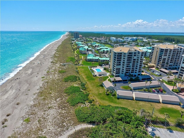 drone / aerial view featuring a view of the beach and a water view