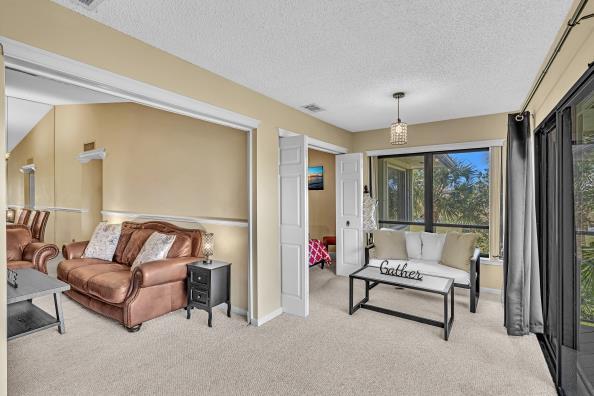 carpeted living room featuring a textured ceiling