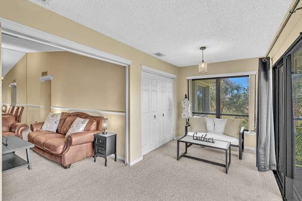 interior space featuring light colored carpet and a textured ceiling